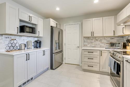a white kitchen with white cabinets and appliances at Boat, Fish and Unwind Waterfront Gem in Pocono Mtns in Lake Ariel