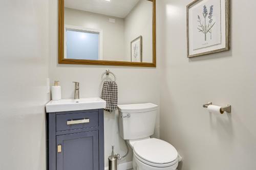 a bathroom with a toilet and a sink and a mirror at Boat, Fish and Unwind Waterfront Gem in Pocono Mtns in Lake Ariel
