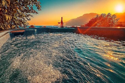 a pool of water with a sunset in the background at Orionas in Tsoútsouros