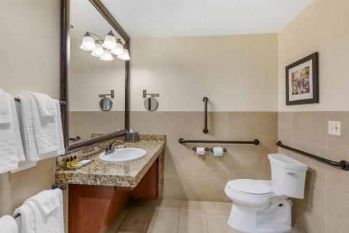 a bathroom with a toilet and a sink and a mirror at Best Western Plus Greenwell Inn in Moab