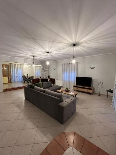 a large living room with a couch and a tv at Margaw's Villa 600m from the beach in Perea