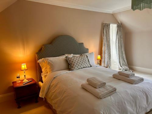 a bedroom with a large bed with towels on it at Clashmore House in Dornoch