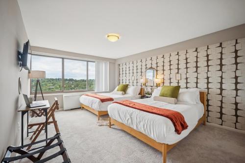 a bedroom with two beds and a window at Boutique Suite-Sleeps 7-Free Parking-Balcony Views in Arlington