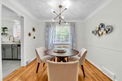 a dining room with a table and chairs at Grosse Pointe Detroit 3BR - Sleeps 8 - Yard home in Grosse Pointe