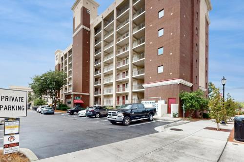a parking lot in front of a large building at Water Street Condos Unit 208 in Wilmington