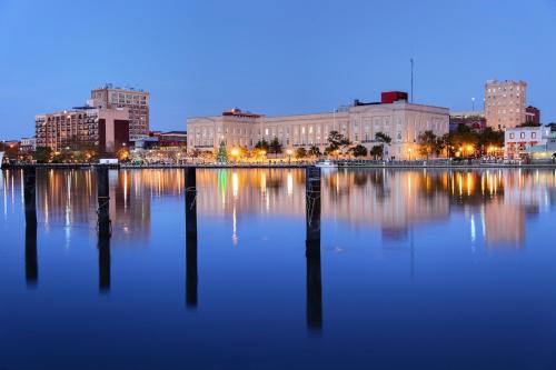 a city skyline with a large body of water at night at Water Street Condos Unit 208 in Wilmington