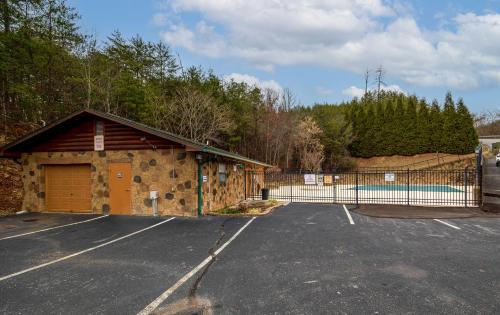 a parking lot with a building with a fence at 1 Above the Smokies by American Patriot Getaways in Williamsburg