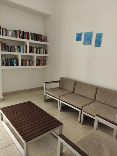 a living room with a couch and a book shelf at “Magic Sunrise at Cancun” in Cancún