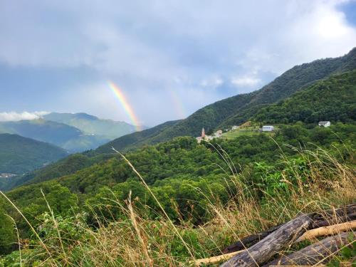 a rainbow in the middle of a mountain at Ca du Bensa 