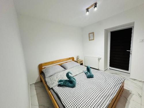 a bedroom with a bed with a blue animal on it at Górska Ostoja in Jugów