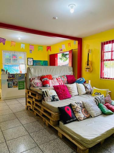 a room with two beds with colorful pillows on them at Pequi hostel in Florianópolis