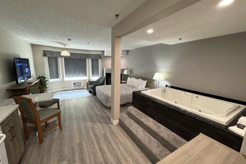a hotel room with a bed and a bath tub at Western Budget Motel Leduc #3 in Leduc
