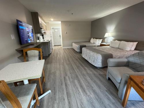 a hotel room with two beds and a couch at Western Budget Motel Leduc #3 in Leduc