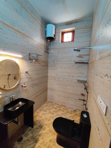 a bathroom with a sink and a toilet and a mirror at The Verandah in Jodhpur