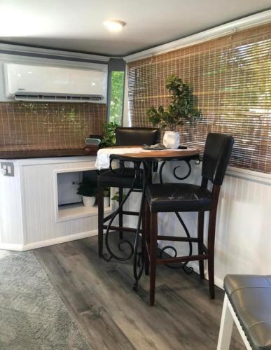 a kitchen with a table and chairs and a fireplace at Baycation Houseboat in Tavernier