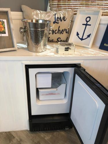 a small refrigerator with its door open on a counter at Baycation Houseboat in Tavernier