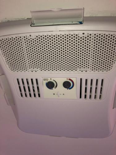a white appliance with eyes on the front of it at Baycation Houseboat in Tavernier
