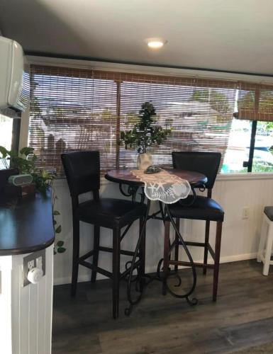 a table and chairs in a room with a window at Baycation Houseboat in Tavernier
