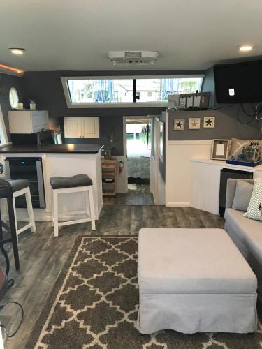 a living room with a couch and a kitchen at Baycation Houseboat in Tavernier