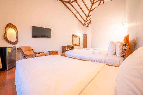Postel nebo postele na pokoji v ubytování Hotel Campestre Cordillera de los Andes