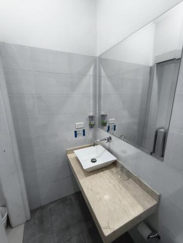 a bathroom with a sink and a mirror at In Situ Hotel in Cali