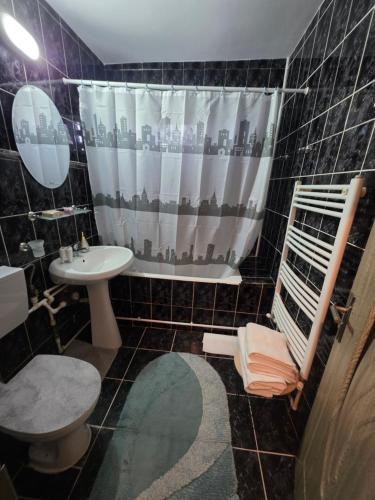 a bathroom with a sink and a shower curtain at Bogdan my sun in Galaţi