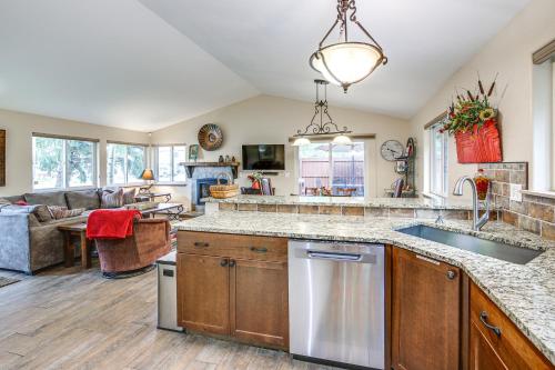 a kitchen with a sink and a living room at Walk to Main St and Ski Shuttle Frisco Home with Yard in Frisco