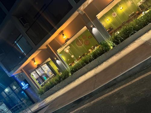 a restaurant with potted plants on the side of a building at HOTEL TERRA NATIVA in Alter do Chao