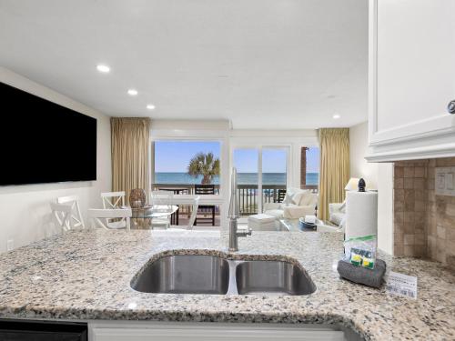 a kitchen with a sink and a view of the ocean at Latitude 29 Condominiums #18 in Sunnyside
