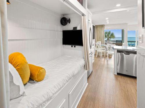 a white room with a couch and a tv at Latitude 29 Condominiums #18 in Sunnyside