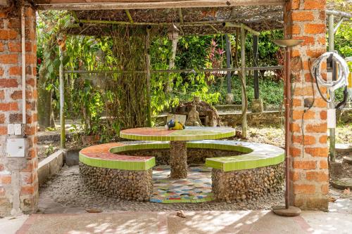 a table and bench in an outdoor area at El susurro del agua exclusiva - natural in Ibagué