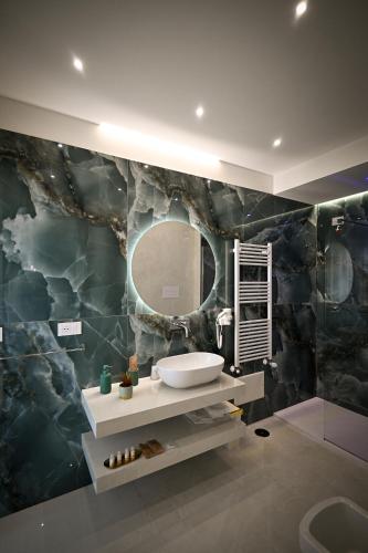 a bathroom with a sink and a mirror at Plaza Rooms Luxury B&B in Pagani