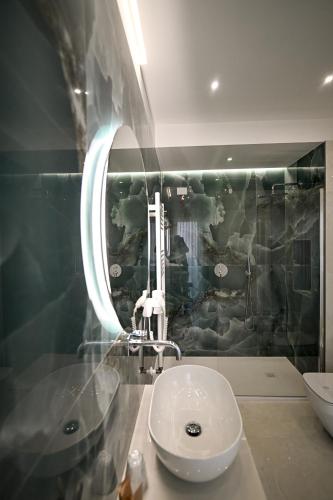 a bathroom with a sink and a mirror at Plaza Rooms Luxury B&B in Pagani