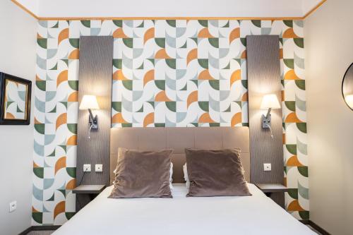 a bedroom with a bed and a colorful wall at Best Western Hotel Saint Claude in Péronne