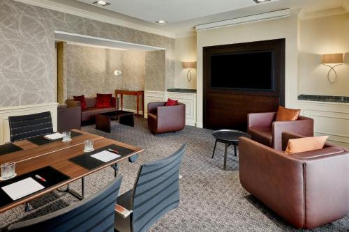 a hotel room with a table and chairs at Hamburg Marriott Hotel in Hamburg