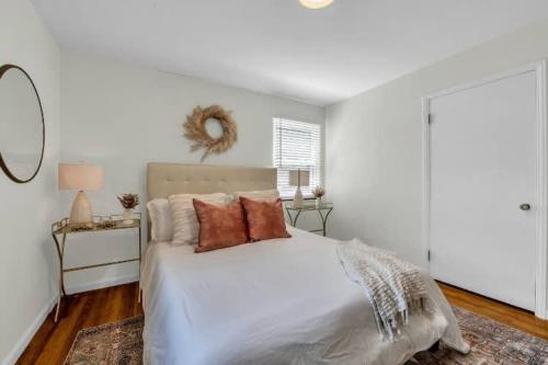 a bedroom with a white bed with pillows on it at Grosse Pointe Detroit 3BR - Sleeps 8 - Yard home in Grosse Pointe