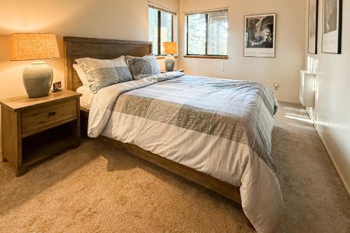 a bedroom with a bed and a night stand with a lamp at Vernal Vista in Yosemite West