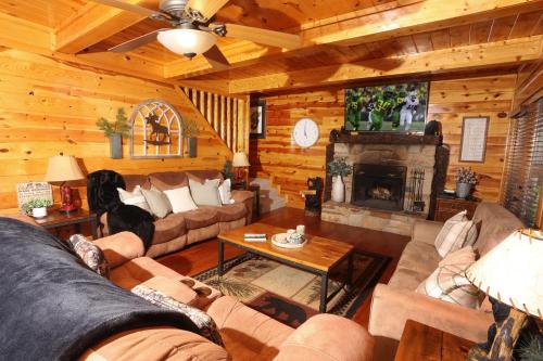 a living room with a couch and a fireplace at Glimpse of Bearadise in Gatlinburg