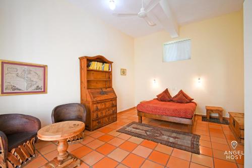 a bedroom with a bed and a table and chairs at Private pool, Oceanview Rooftop in Historic La Paz in La Paz