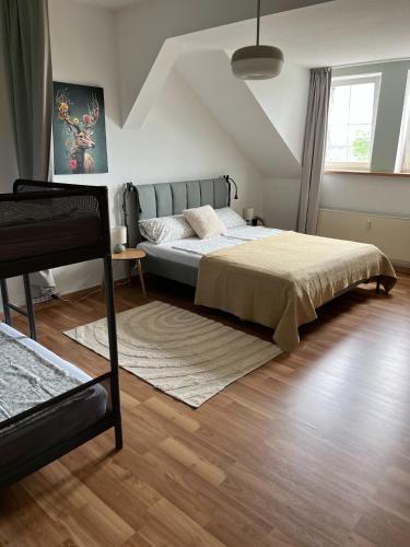 a bedroom with a large bed and a wooden floor at K2-Project - Hotspot - am Puls der Stadt in Chemnitz