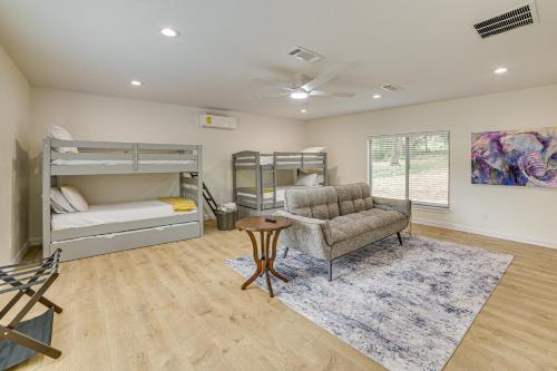a living room with a chair and a couch and bunk beds at Private Dock Waterfront Cedar Creek Lake Home in Eustace