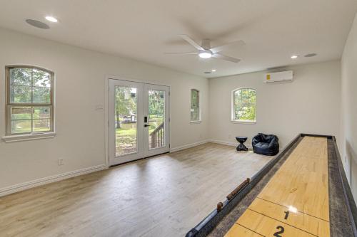 an empty living room with a ping pong table at Private Dock Waterfront Cedar Creek Lake Home in Eustace