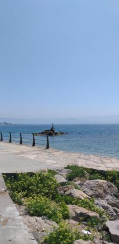 a beach with rocks and the ocean in the background at Casa Machado in Cangas de Morrazo