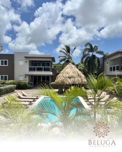 a resort with a swimming pool and palm trees at Beluga Apartments Curacao - nabij Willemstad & Mambo Beach in Willemstad