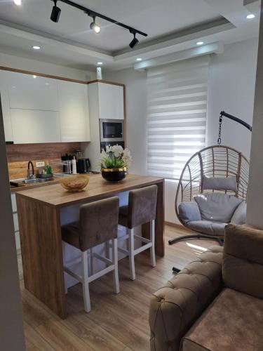 a kitchen with a island with chairs and a couch at Long beach luxury Premium apartments in Ulcinj