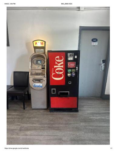 a coca cola machine next to a soda machine at Roxy Hotel in Los Angeles