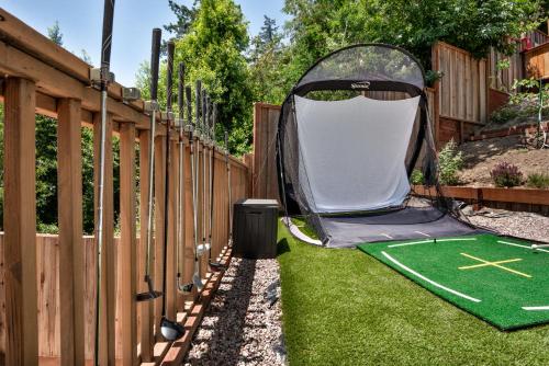 a backyard with a putting green and a miniature golf course at Skyview Grove Cabin 