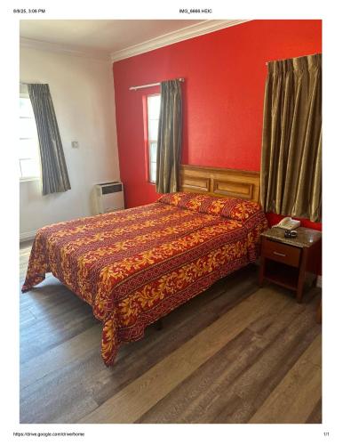 a bedroom with a bed with a red wall at Roxy Hotel in Los Angeles