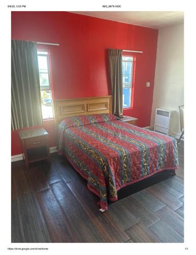 a bedroom with a bed with a red wall at Roxy Hotel in Los Angeles