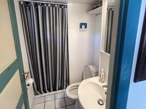 a bathroom with a black shower curtain and a toilet at 4 person holiday home in Ærøskøbing-By Traum in Ærøskøbing
